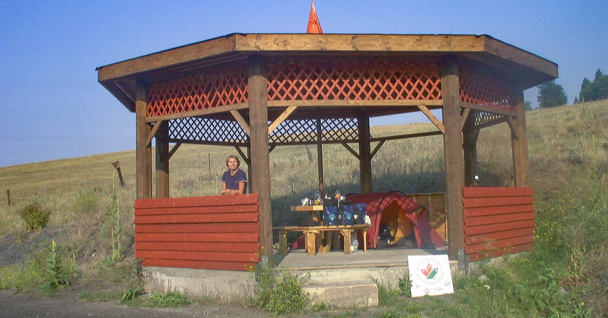 Zelt und Packtaschen mit Holztisch und Bänken in Holzhütte auf dem KVR